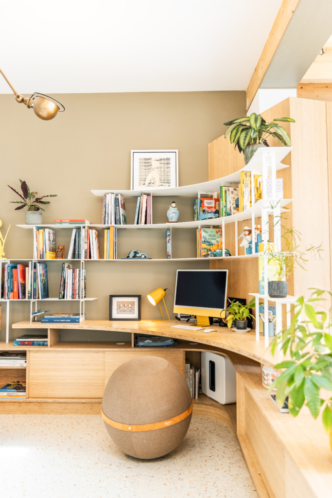 Bureau en coin courbe avec bibliothèque intégrée. Combinaison de bois et acier.