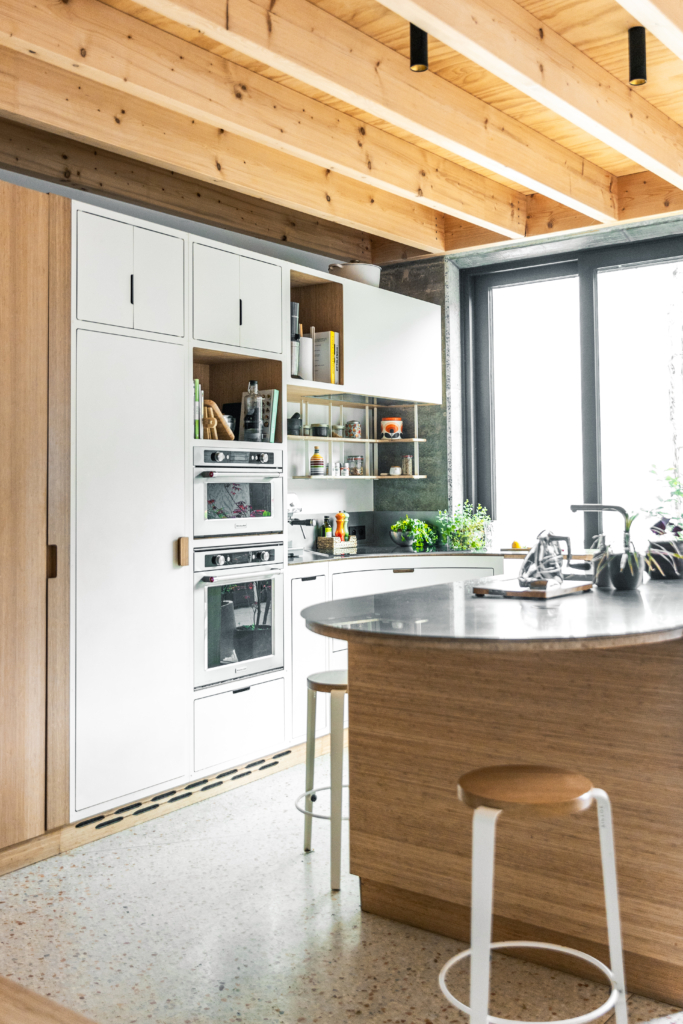 Interior design project to fit out a first floor. Custom-made kitchen area with interface to dining room. Combination of wood and steel.