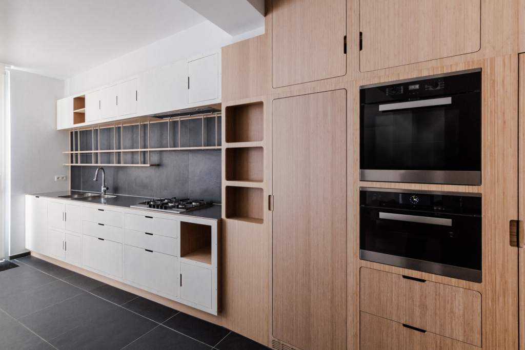 Projet de cuisine sur-mesure avec îlot pour un cuisinier professionnel. Meubles combinant revêtements en bois et acier