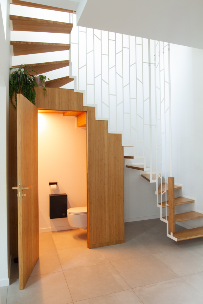 Custom-made suspended staircase with toilet and built-in furniture
