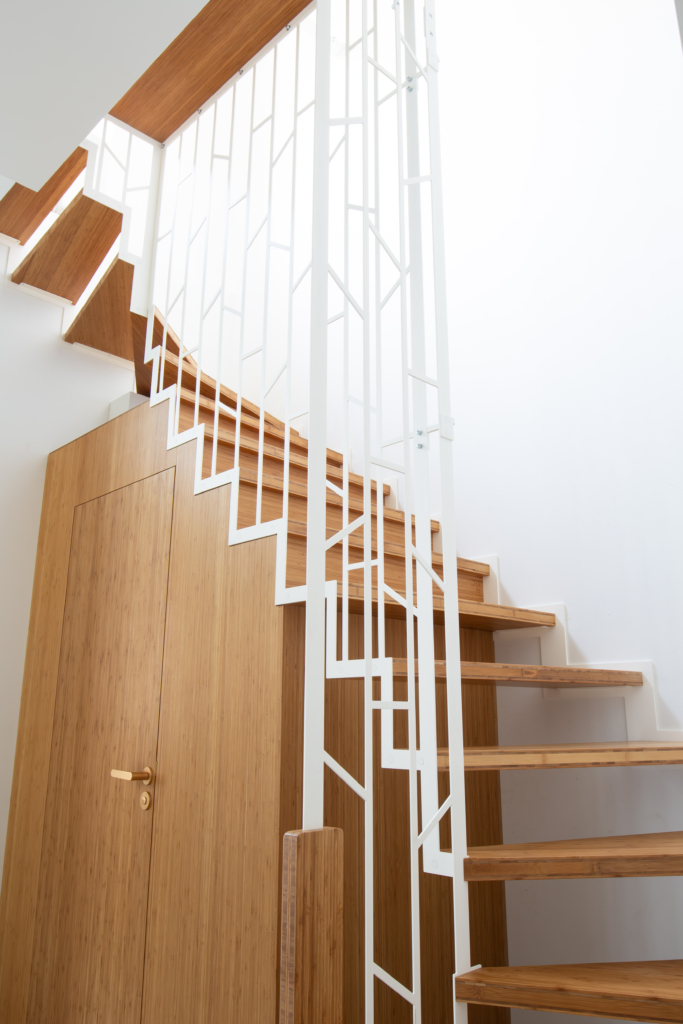 Custom-made suspended staircase with toilet and built-in furniture